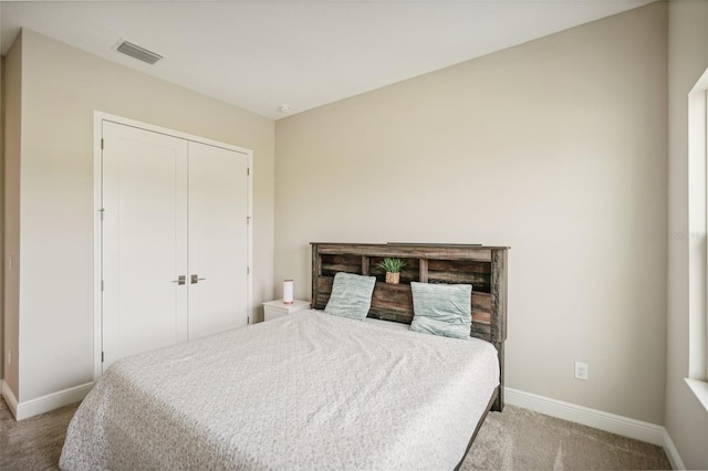 bedroom with light colored carpet and a closet