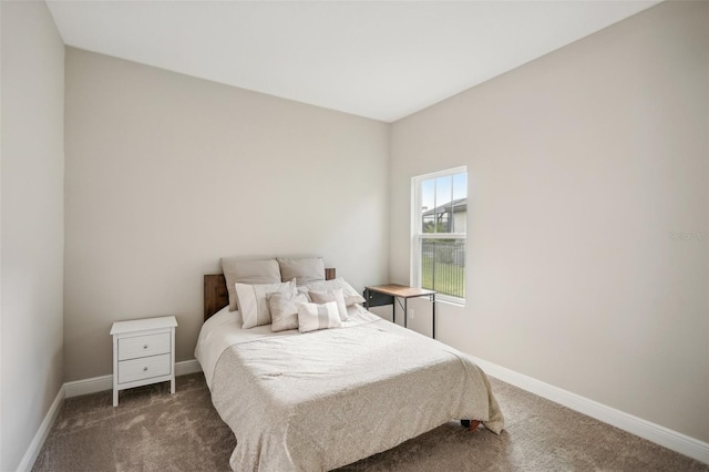 bedroom featuring dark colored carpet