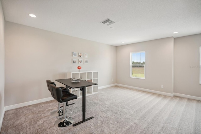 office with light carpet and a textured ceiling