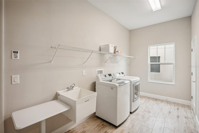 laundry room with washing machine and dryer and sink