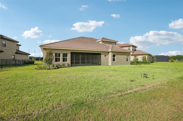 back of property with a lawn