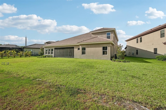 back of property with a lawn