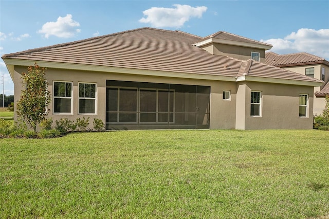 rear view of property with a lawn