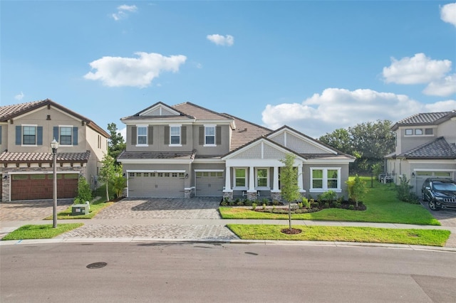 view of front of house with a front yard and a garage