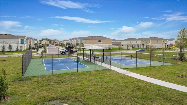 view of tennis court with a gazebo and a yard