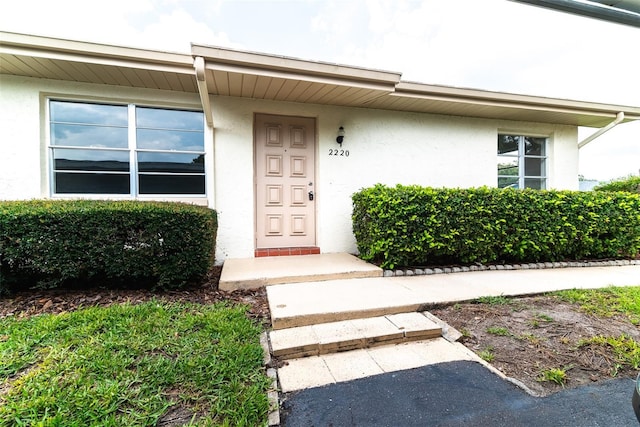 property entrance featuring stucco siding