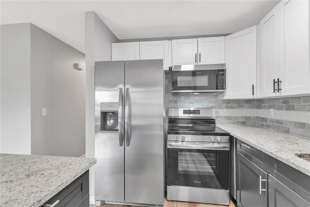 kitchen with white cabinetry, appliances with stainless steel finishes, and backsplash