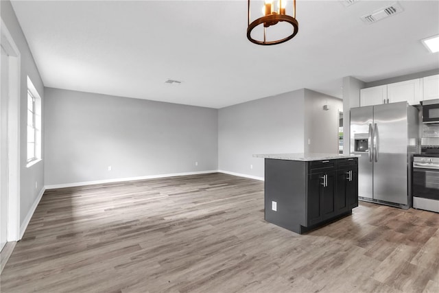 kitchen with visible vents, stainless steel appliances, white cabinetry, and light wood-style floors