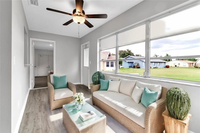 interior space featuring a residential view, visible vents, and a ceiling fan