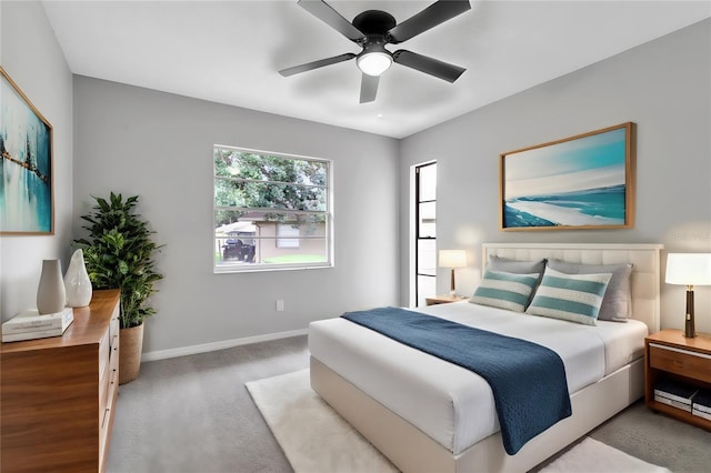 carpeted bedroom with ceiling fan and baseboards