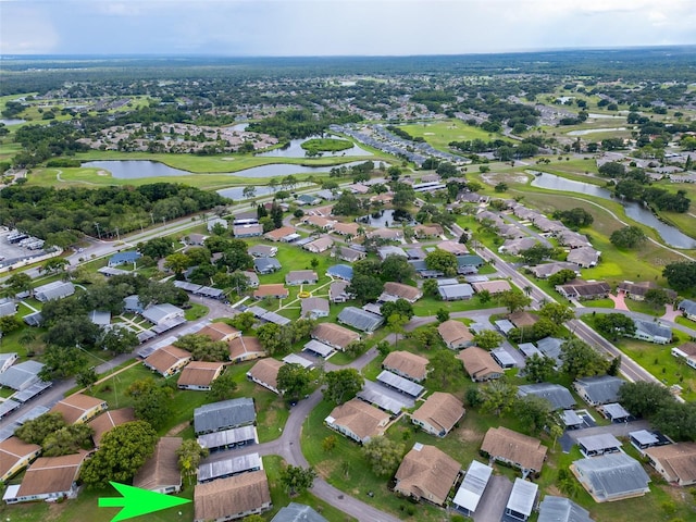 birds eye view of property featuring a water view, a residential view, and golf course view