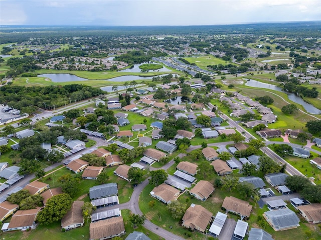 bird's eye view with a water view, a residential view, and golf course view