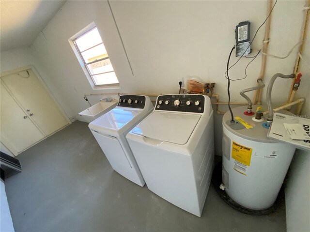 laundry area with laundry area, electric water heater, a sink, and washing machine and clothes dryer