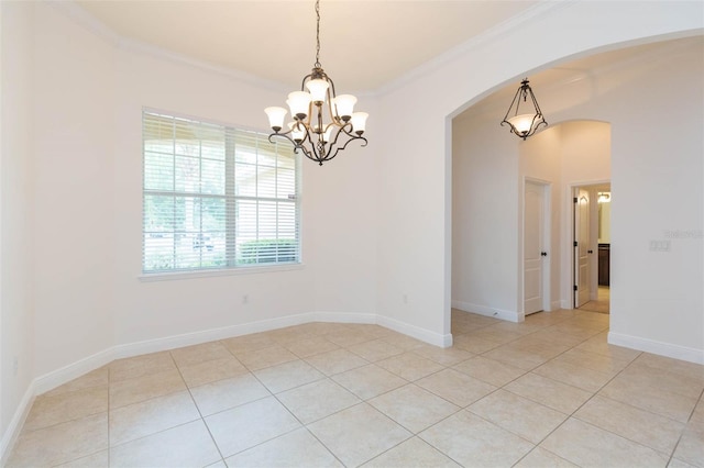 tiled spare room with an inviting chandelier and crown molding