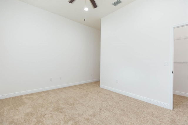 carpeted spare room with ceiling fan