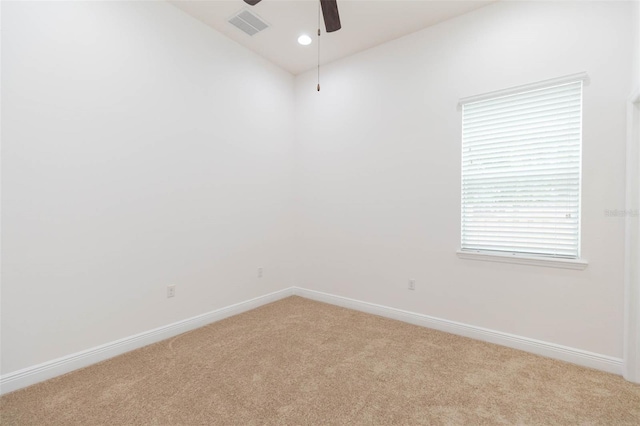 carpeted spare room featuring ceiling fan