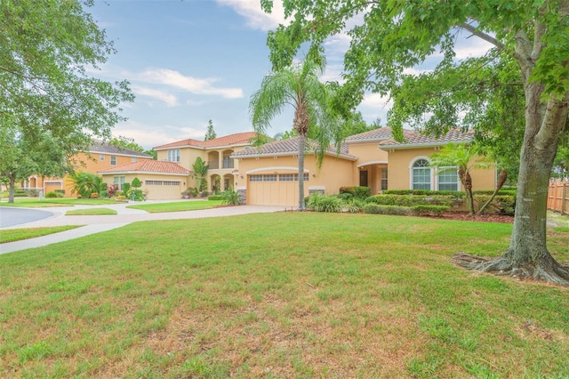 mediterranean / spanish-style house featuring a front lawn and a garage