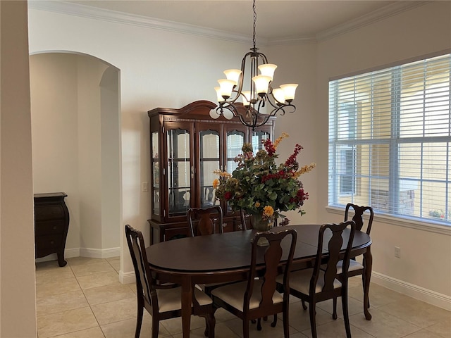 dining space with light tile patterned floors, ornamental molding, and a chandelier