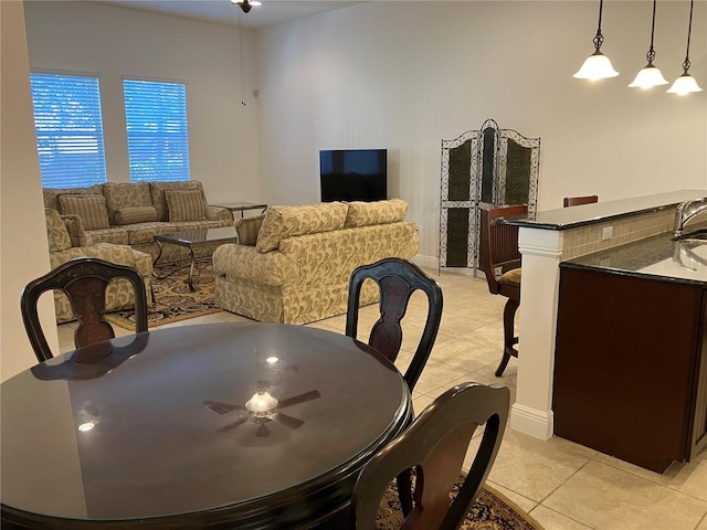 tiled dining room with ceiling fan