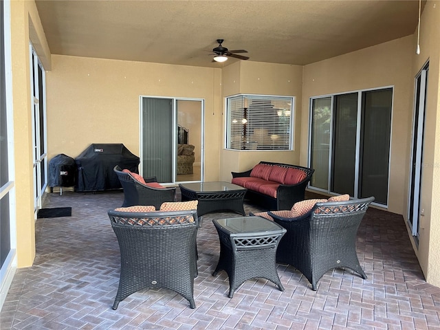 view of patio with ceiling fan, area for grilling, and an outdoor hangout area