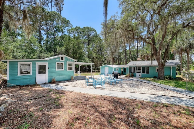 rear view of property with a carport