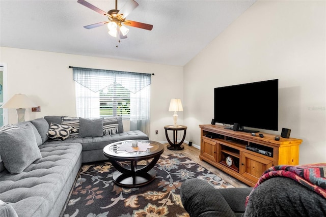 living room featuring hardwood / wood-style flooring, ceiling fan, and lofted ceiling