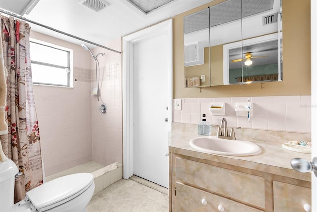 bathroom featuring a shower with curtain, vanity, ceiling fan, tile walls, and toilet