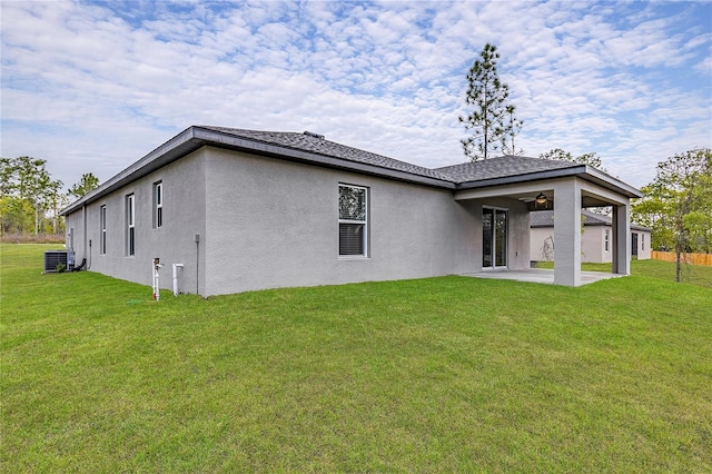 back of property featuring a patio, central AC unit, ceiling fan, and a lawn