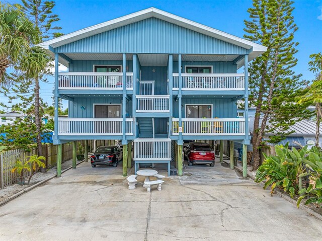 view of front of home featuring a carport and a balcony