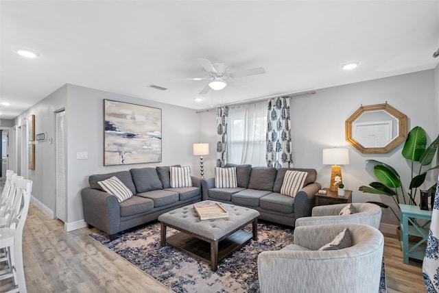 living room featuring ceiling fan and light wood-type flooring