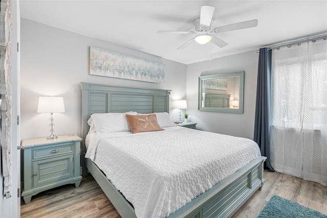 bedroom featuring multiple windows, ceiling fan, and light hardwood / wood-style floors