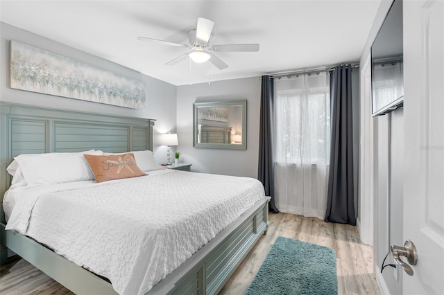 bedroom with ceiling fan and light hardwood / wood-style flooring