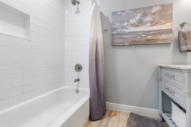 bathroom featuring hardwood / wood-style flooring and shower / bathtub combination with curtain