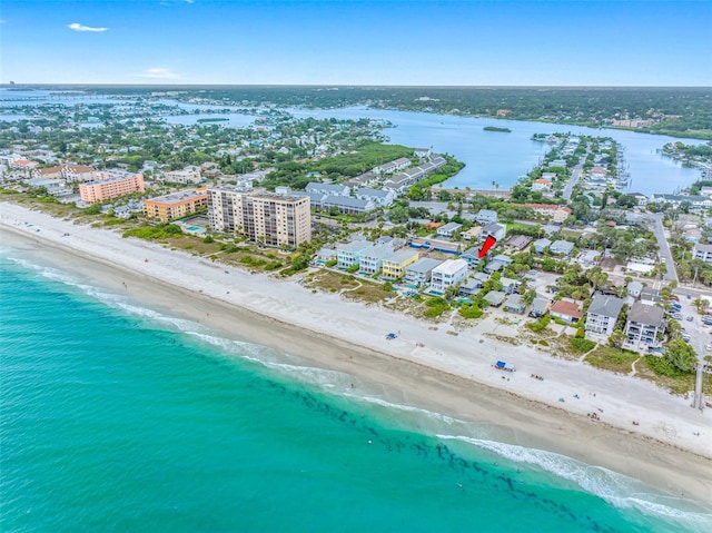 birds eye view of property with a view of the beach and a water view