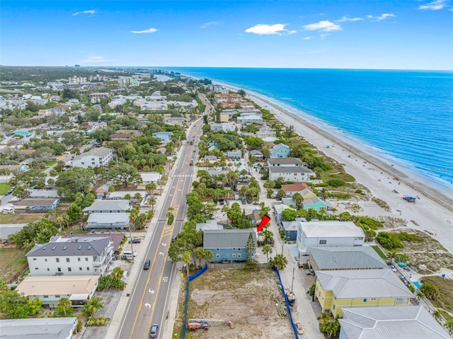 drone / aerial view featuring a water view and a view of the beach