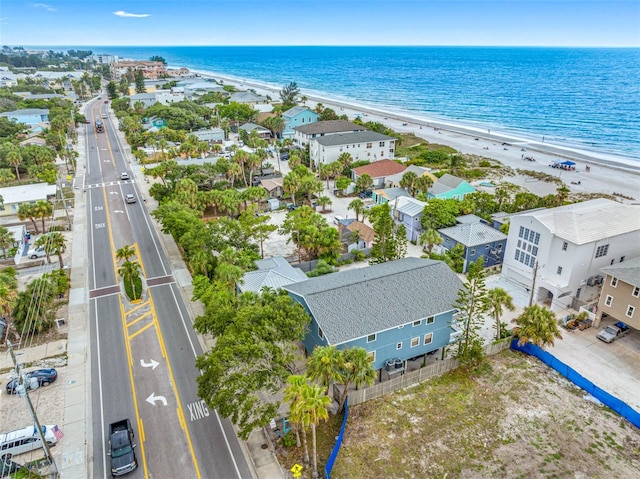 drone / aerial view featuring a water view and a beach view