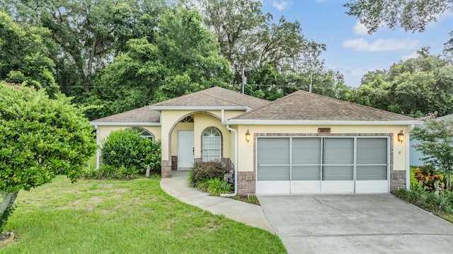 view of front of home with a garage and a front lawn