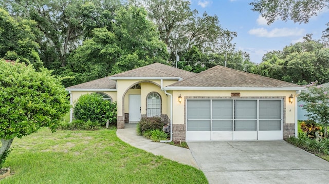 view of front of property featuring a garage and a front lawn