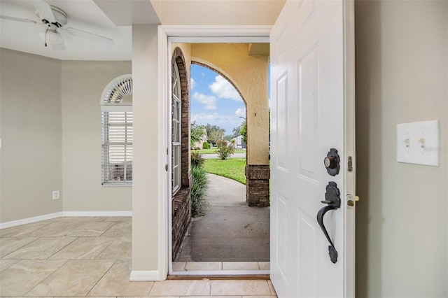 tiled foyer entrance with ceiling fan