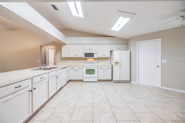 kitchen featuring sink, white appliances, light tile patterned floors, white cabinets, and vaulted ceiling