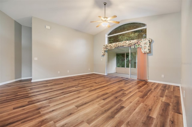 empty room with hardwood / wood-style flooring, high vaulted ceiling, and ceiling fan