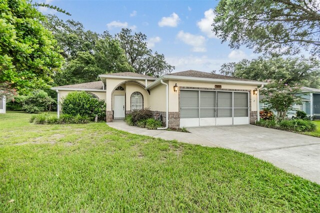 ranch-style house with a garage and a front yard