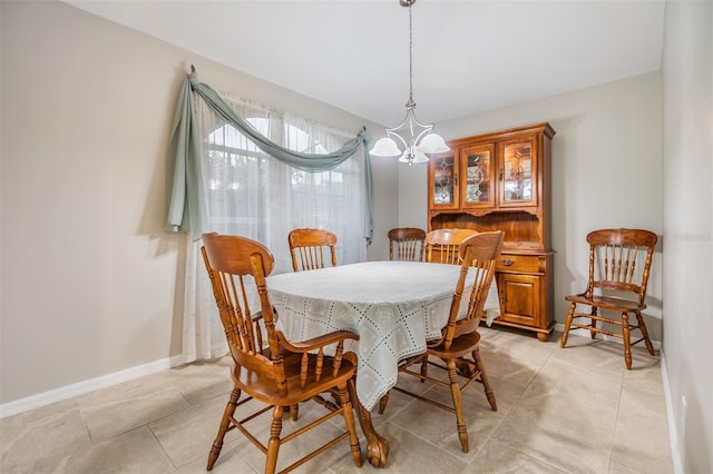 tiled dining space featuring an inviting chandelier