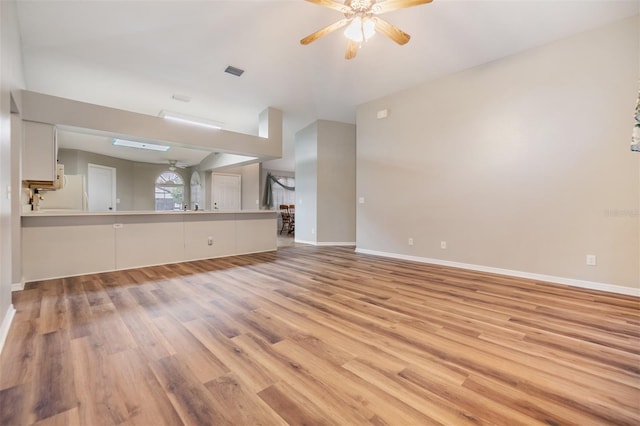 unfurnished living room with ceiling fan and light hardwood / wood-style floors