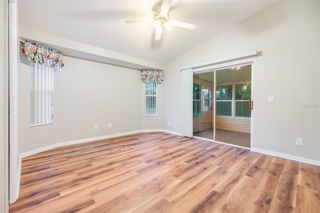 spare room with vaulted ceiling, ceiling fan, and light wood-type flooring