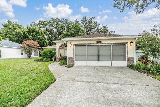 ranch-style house with a garage and a front lawn