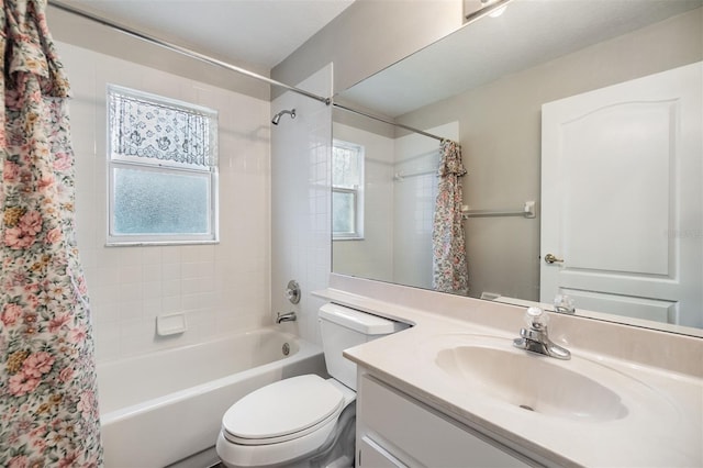 full bathroom with vanity, shower / bath combo, and toilet