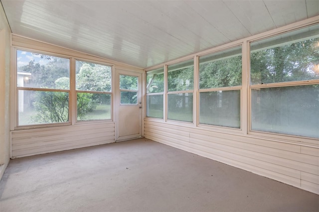 unfurnished sunroom featuring vaulted ceiling and wooden ceiling