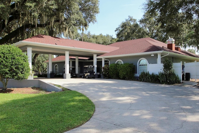 view of front of property with a front yard and a carport