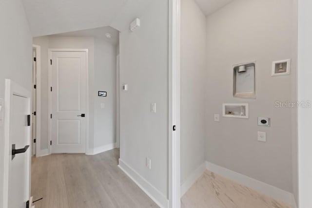 clothes washing area with hookup for a washing machine, light hardwood / wood-style flooring, and hookup for an electric dryer